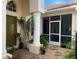 Inviting entryway with a green door and terracotta tile flooring at 7818 33Rd E St, Sarasota, FL 34243