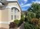 Well-maintained house exterior with a landscaped walkway at 7818 33Rd E St, Sarasota, FL 34243