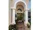 Elegant front entry with arched detail and double columns at 7818 33Rd E St, Sarasota, FL 34243