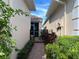 Brick-paved pathway leads to a private backyard with a screened enclosure at 7818 33Rd E St, Sarasota, FL 34243