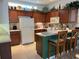 Well-equipped kitchen with wood cabinets, breakfast bar, and tile flooring at 7818 33Rd E St, Sarasota, FL 34243