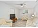 Living room with light walls, off white couches and wood floors at 906 Columbia Ter, Port Charlotte, FL 33948