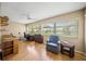 Home office features built-in shelving, hardwood floors and a relaxing armchair at 6052 Bonaventure Pl, Sarasota, FL 34243