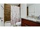 Updated bathroom with wood-look tile and granite vanity at 823 32Nd E Ave, Bradenton, FL 34208