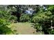 Large backyard with mature trees and lush landscaping at 823 32Nd E Ave, Bradenton, FL 34208