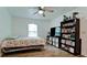 Bedroom with large bookcase, TV and ceiling fan at 823 32Nd E Ave, Bradenton, FL 34208