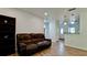 Living room with brown leather couch and wood-look tile flooring at 823 32Nd E Ave, Bradenton, FL 34208