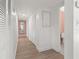 Clean hallway with white louvered doors and light wood floors at 3755 Beach Se Dr, St Petersburg, FL 33705