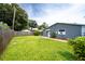 Home's backyard with grassy lawn and wooden fence at 4573 Mcintosh Ln, Sarasota, FL 34232