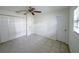 Bedroom with tile floors, ceiling fan, and built-in closet at 4573 Mcintosh Ln, Sarasota, FL 34232