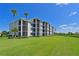 Condo building with lush landscaping and lawn at 850 Tidewater Shores Loop # 102, Bradenton, FL 34208