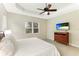 Bright bedroom with a king-size bed and mounted TV at 4015 Celestial Blue Ct, Bradenton, FL 34211