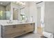 Modern double vanity with wood cabinets and gold fixtures at 2425 Temple St, Sarasota, FL 34239