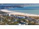 Aerial view of beautiful beach, buildings and turquoise waters on a sunny day at 2425 Temple St, Sarasota, FL 34239