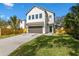 Modern two-story home with driveway, landscaping, and fenced yard at 2425 Temple St, Sarasota, FL 34239