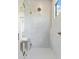 Walk-in shower with gray tile and gold fixtures at 2425 Temple St, Sarasota, FL 34239