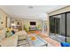 Bright living room with terracotta tile flooring, stylish decor, and a view to outdoor courtyard at 3902 Glen Oaks Manor Dr, Sarasota, FL 34232