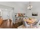 Elegant dining room with hardwood floors and a view into the kitchen at 4573 Kingsmere # 27, Sarasota, FL 34235