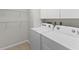 Convenient laundry room with washer and dryer and additional shelving at 4573 Kingsmere # 27, Sarasota, FL 34235