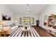 Bright living room with hardwood floors, comfortable seating, and access to a screened patio at 4573 Kingsmere # 27, Sarasota, FL 34235