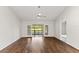 Spacious living area featuring hardwood floors and sliding glass doors leading to the outdoors at 4573 Kingsmere # 27, Sarasota, FL 34235