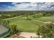 Driving range with lush grass and lake view at 5092 Mahogany Run Ave, Sarasota, FL 34241