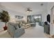Bright living room with comfy sofas, a coffee table, and access to a screened lanai at 5092 Mahogany Run Ave, Sarasota, FL 34241