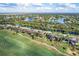Aerial view showcasing home location near golf course and water at 5092 Mahogany Run Ave, Sarasota, FL 34241