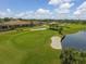 Aerial view of golfers on a green near a clubhouse at 5092 Mahogany Run Ave, Sarasota, FL 34241
