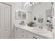 Double vanity bathroom with white cabinets and a large mirror at 5092 Mahogany Run Ave, Sarasota, FL 34241
