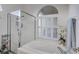 Bathroom with shower, bathtub and window with plantation shutters at 5092 Mahogany Run Ave, Sarasota, FL 34241