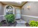 Front entry with white door and arched window at 5092 Mahogany Run Ave, Sarasota, FL 34241