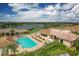 Aerial view of community pool and clubhouse with surrounding landscape at 5092 Mahogany Run Ave, Sarasota, FL 34241