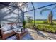 Relaxing screened lanai overlooks lush landscaping and golf course at 5092 Mahogany Run Ave, Sarasota, FL 34241