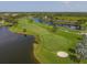 Aerial view of a golf course with water features and greens at 5092 Mahogany Run Ave, Sarasota, FL 34241