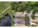 Aerial view of home with pool surrounded by a golf course and pond at 7204 Saint Georges Way, University Park, FL 34201