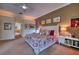 Bedroom featuring a ceiling fan, neutral carpeting, and an ensuite bathroom at 7204 Saint Georges Way, University Park, FL 34201