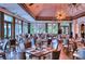 Elegant dining room with tables set, chandelier lighting, and ample natural light at 7204 Saint Georges Way, University Park, FL 34201