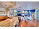 Bright living room showcasing a fireplace, hardwood floors, and an open layout with the adjacent kitchen at 7204 Saint Georges Way, University Park, FL 34201