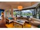 Bright living room featuring a yellow rug, modern furnishings, and views of the pool and outdoor space at 7204 Saint Georges Way, University Park, FL 34201