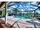 Inviting screened pool area featuring a beautiful view of the adjacent golf course and lake at 7204 Saint Georges Way, University Park, FL 34201