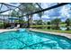 Screened pool and spa overlooks a picturesque lake and golf course at 7204 Saint Georges Way, University Park, FL 34201