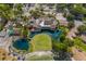 Aerial view of clubhouse, golf course, and pond at 4573 Kingsmere # 27, Sarasota, FL 34235