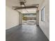 Single-car garage with open door, revealing a view of the community at 4573 Kingsmere # 27, Sarasota, FL 34235