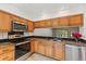 Light wood cabinets, stainless steel appliances, and granite countertops at 4573 Kingsmere # 27, Sarasota, FL 34235