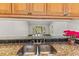 Kitchen sink with granite countertop and view into living area at 4573 Kingsmere # 27, Sarasota, FL 34235