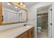 Bathroom with light wood vanity, large mirror, and shower at 4573 Kingsmere # 27, Sarasota, FL 34235