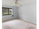 Spacious carpeted bedroom with large window and golf course view at 4573 Kingsmere # 27, Sarasota, FL 34235