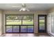 Bright screened porch overlooking a lush green golf course at 4573 Kingsmere # 27, Sarasota, FL 34235