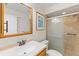 Bathroom with light wood vanity, large mirror and shower/tub combo at 4573 Kingsmere # 27, Sarasota, FL 34235